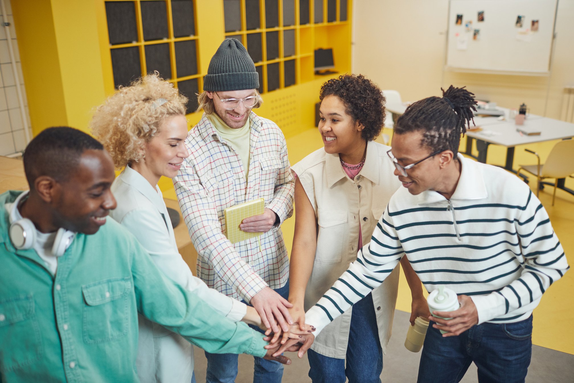 A Group of People Cooperating with Their Hands Together